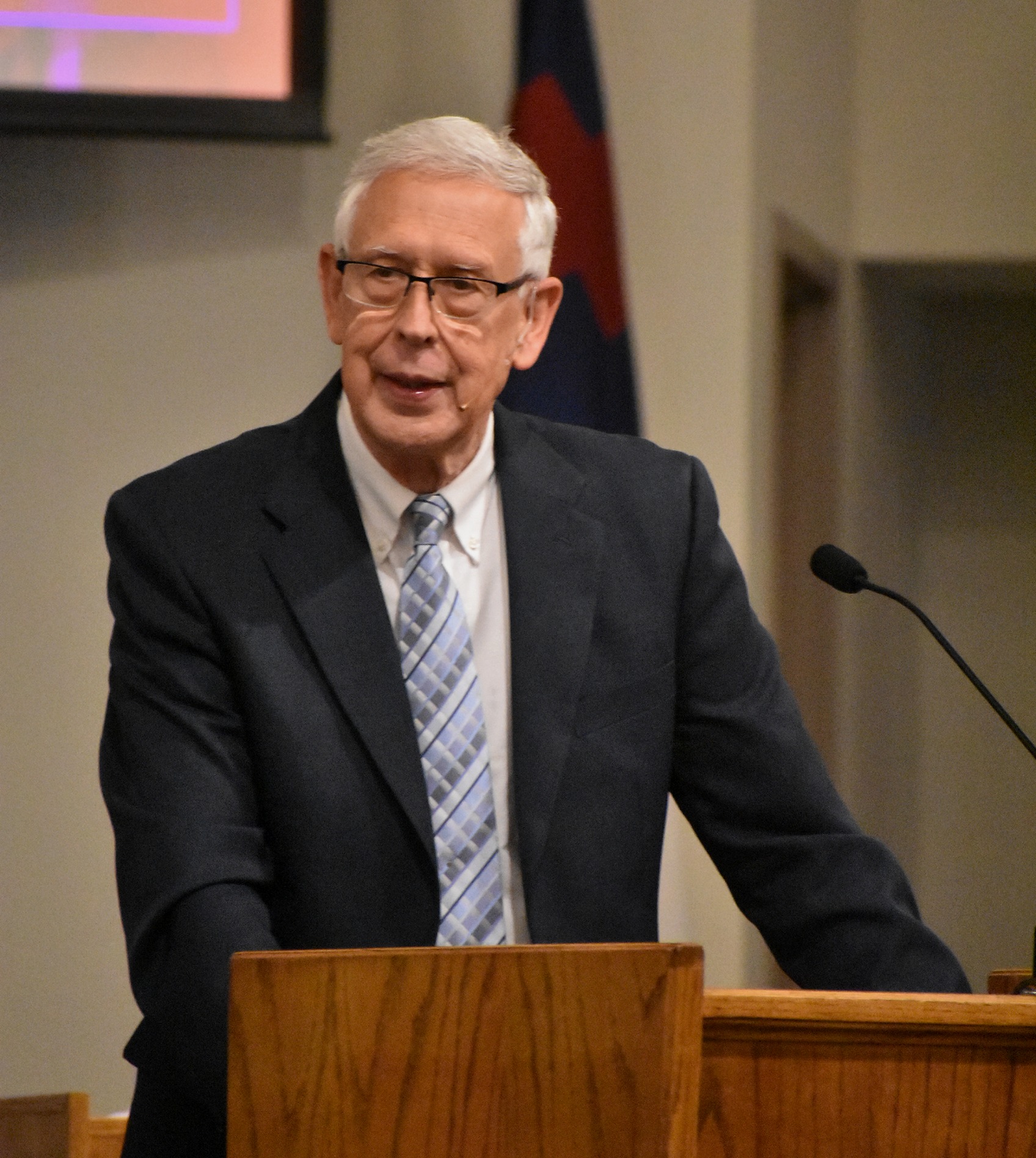 Dr. David Zempel preaching from the pulpit